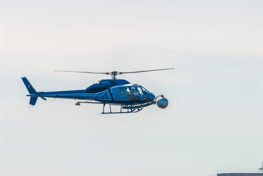Helicopter over the Charles River with sky in background