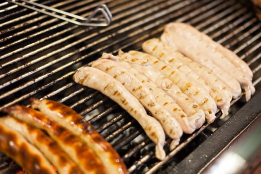 German sausages being grilled over coal outdoors