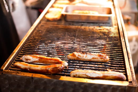 German sausages being grilled over coal outdoors