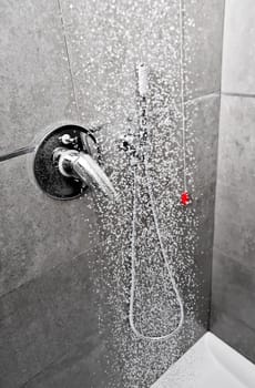 Shower handle with water falling on the flloor