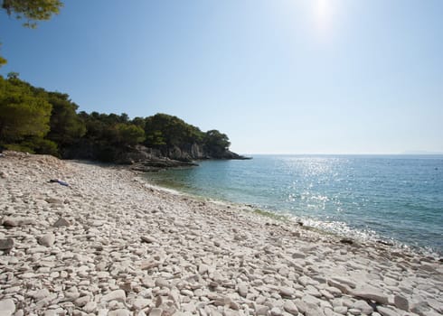 White stony beach in Croatia wiht sunshine