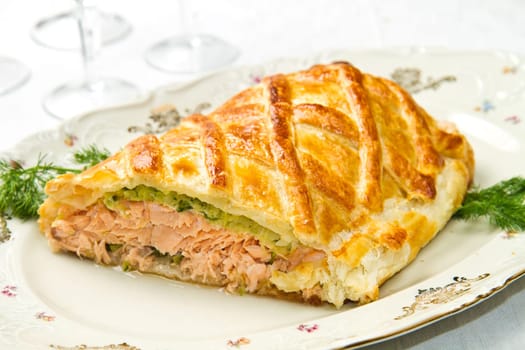 Traditional salmon in puff pastry with spinach and zucchini