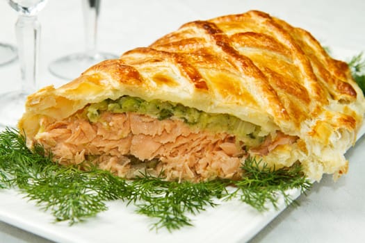 Traditional salmon in puff pastry with spinach and zucchini