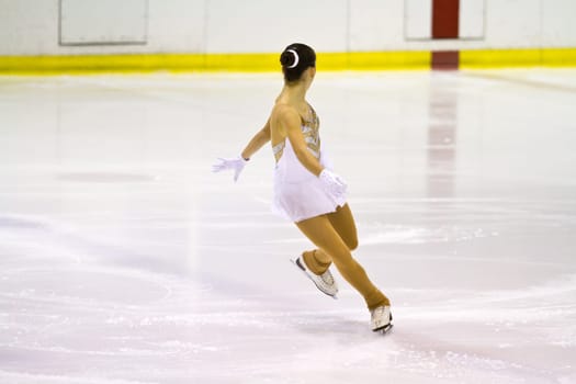 woman figure skater performing  on ice