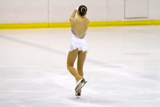 woman figure skater performing  on ice