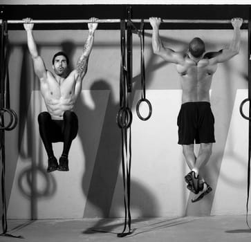 Crossfit toes to bar men pull-ups 2 bars workout exercise at gym