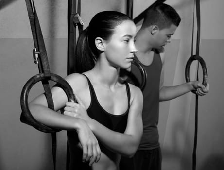 Crossfit dip ring man and woman relaxed after workout at gym dipping exercise