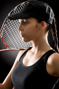 Tennis woman portrait female player with racket on black background