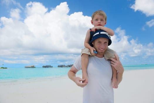 Portrait of a happy family on summer vacation  at beach