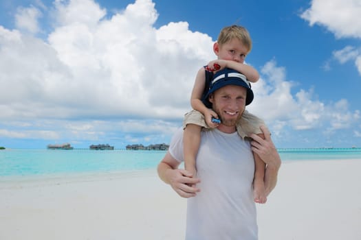 Portrait of a happy family on summer vacation  at beach