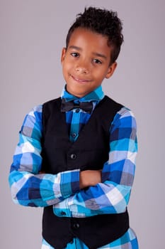 Portrait of a cute african american little boy with folded arms, isolated on white background