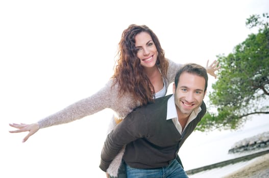 Portrait of a happy young couple having fun on the beach