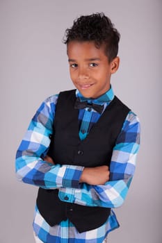 Portrait of a cute african american little boy with folded arms, isolated on white background