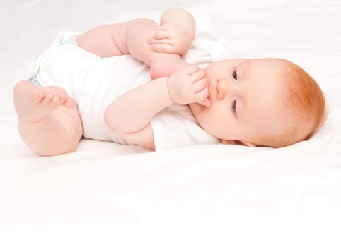 Cute Baby Girl Sucking Her Toes on White Background
