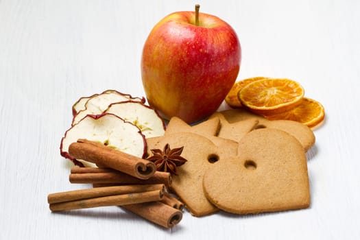 fresh apple with biscuit,cinnamon and fruit dried on white background