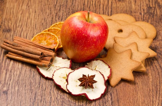 fresh apple with biscuit,cinnamon and fruit dried on wooden table