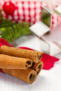 cinnamon sticks with decoration on white