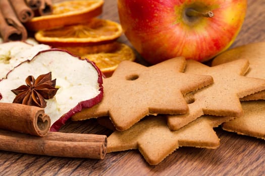 fresh apple with biscuit,cinnamon and fruit dried on wooden table