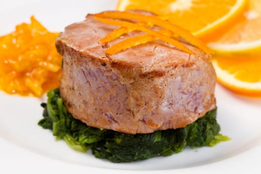 fried tuna fillet with fresh orange ,orange sauce and spinach