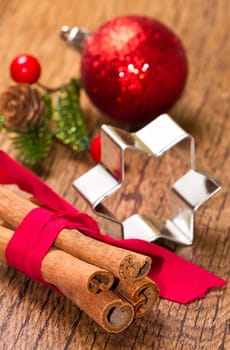 cinnamon sticks with decoration on wooden background