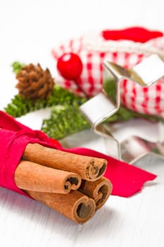 cinnamon sticks with decoration on white