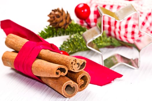 cinnamon sticks with decoration on white