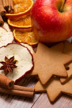 fresh apple with biscuit,cinnamon and fruit dried on wooden table
