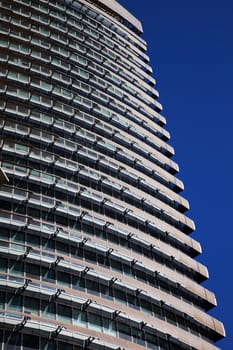 Perspective and underside angle view of modern glass building skyscrapers over blue sky