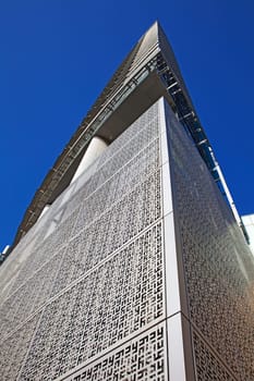 Perspective and underside angle view of modern glass building skyscrapers over blue sky