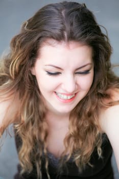 Portrait of a happy caucasian young woman laughing.