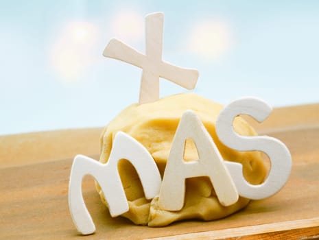 Seasonal background with freshly prepared dough left to rise on a kitchen countertop decorated with the letters XMAS for preparing Christmas cookies for family and friends