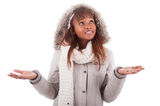 Young african american woman wearing winter clothes holding something in her hand, isolated on white background