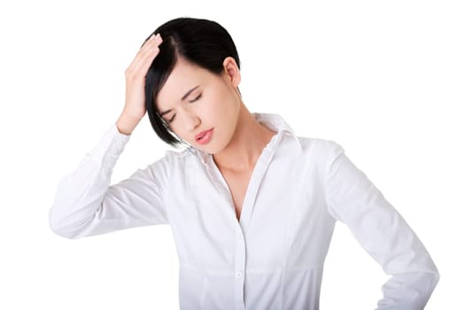 A businesswoman with a headache holding head, isolated on white background