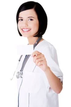 Woman doctor or nurse holding business card in her hand