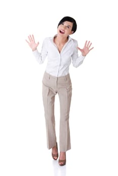 Portrait of surprised excited young business woman looking up, over grey background