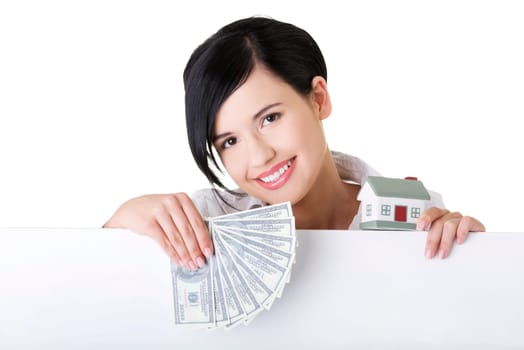 Business woman with blank sign board holding house model and money. Real estate loan concept