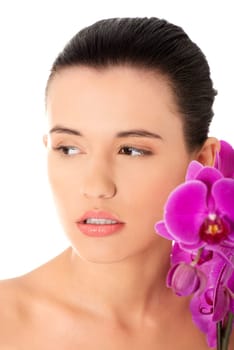 Portrait of beautiful young woman with health skin and with orchid flower