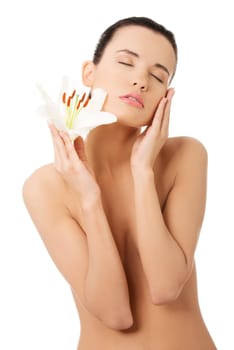 Portrait of beautiful young woman with health skin and with lily flower