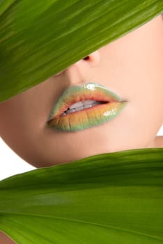 Woman's lips with green leafs
