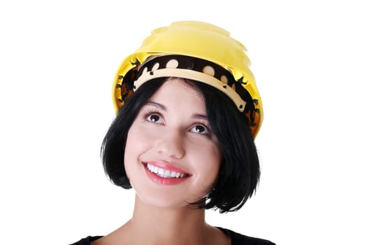 Portrait of confident female worker in helmet looking up. Isolated on white