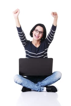 Happy young woman using her laptop, isolated on white.