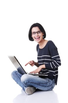 Happy young woman using her laptop, isolated on white.