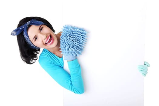 Smiling happy cleaning woman showing blank sign board.