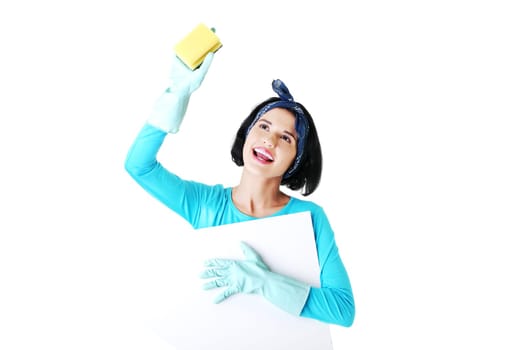 Smiling happy cleaning woman showing blank sign board.