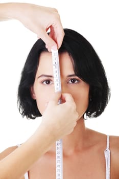 Woman head being measured by female hands