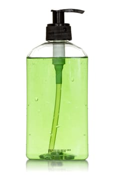 Transparent bottle with green  liquid soap on white background