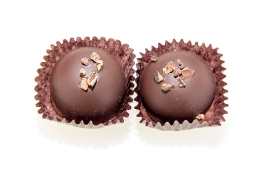 Two Dark Gourmet Chocolate Truffles Isolated on White Background