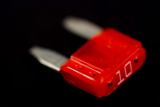 electrical automobile fuses with shallow depth of field on black background