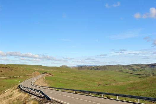 Landscape in Extremadura with castle ruins on the horizon