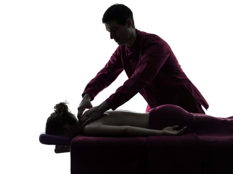 woman receiving shoulder massage  in silhouette studio on white background